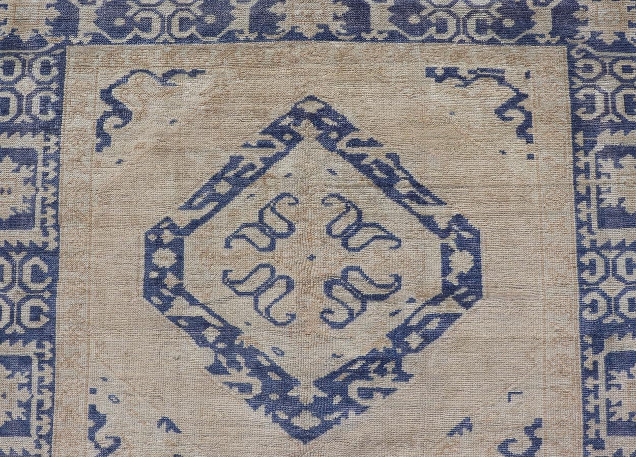 Turkish Oushak Gallery Rug in Blue and Cream with Geometric Design Measures: 4'6 x 12'6 This vintage Oushak gallery runner features blue medallions on a sandy - taupe field. The border and central medallions are both rendered in a rich me... - Keivan Woven ArtsEN - 178699 - 18896Rug