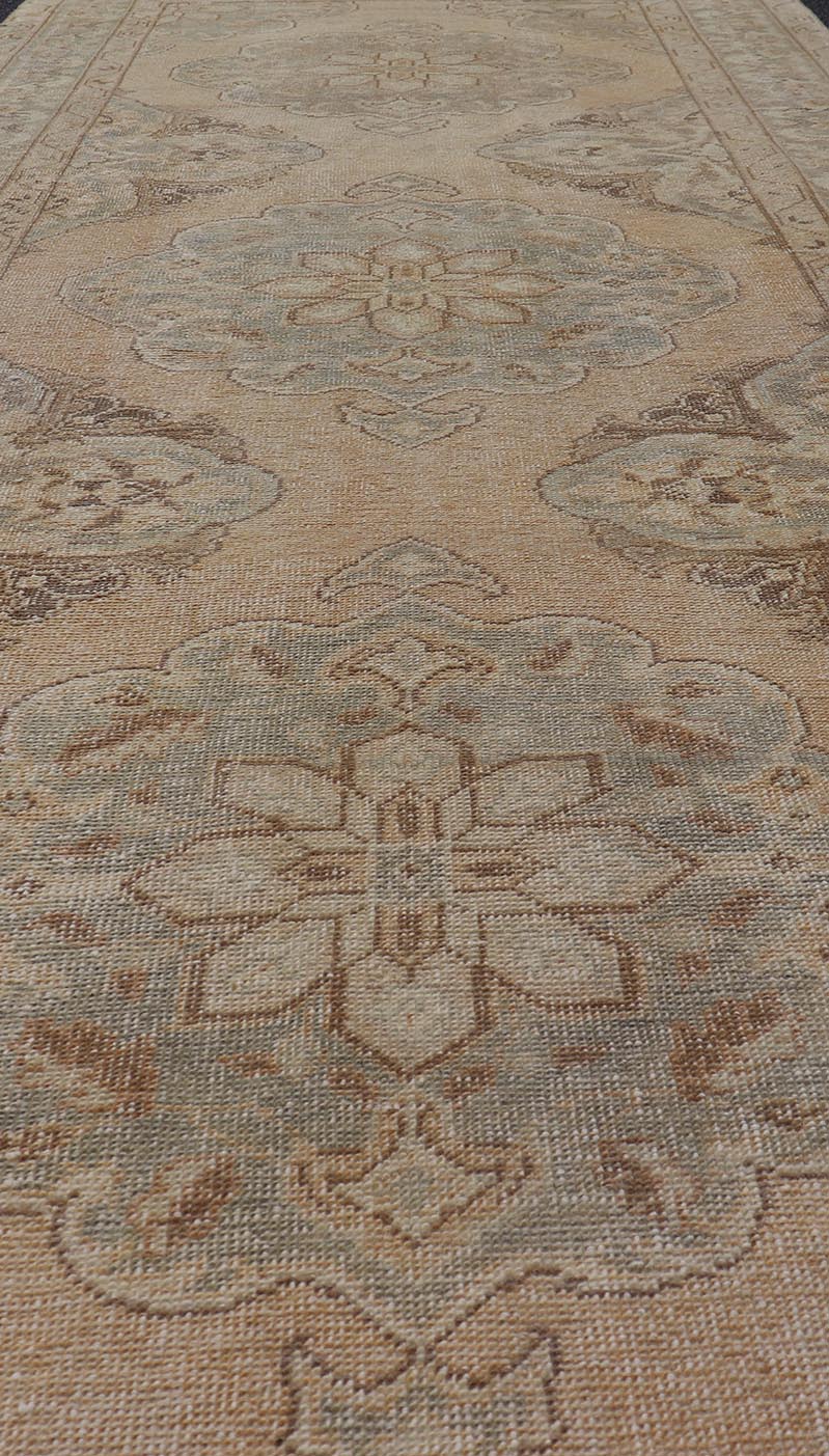 Measures: 4'3 x 11'7 Vintage Turkish Gallery Rug in Earth Tones & Light Grey with Floral Medallions. Keivan Woven Arts / Rug / EN - 178758, Keivan Woven Arts / country of origin / type: Turkey / Oushak, circa 1940. This beautiful vintage Ousha... - Keivan Woven ArtsEN - 178758 - 21925Rug