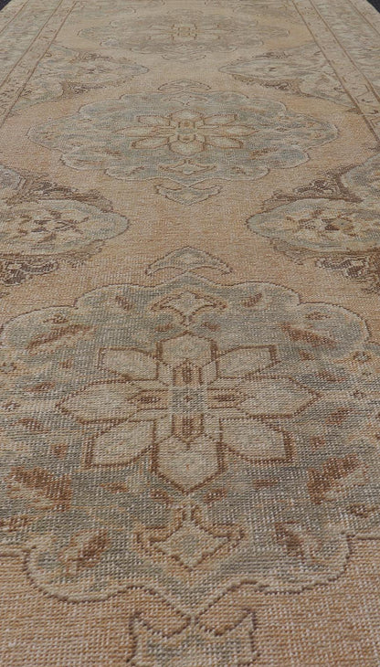 Measures: 4'3 x 11'7 Vintage Turkish Gallery Rug in Earth Tones & Light Grey with Floral Medallions. Keivan Woven Arts / Rug / EN - 178758, Keivan Woven Arts / country of origin / type: Turkey / Oushak, circa 1940. This beautiful vintage Ousha... - Keivan Woven ArtsEN - 178758 - 21925Rug