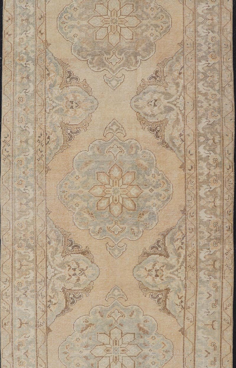 Measures: 4'3 x 11'7 Vintage Turkish Gallery Rug in Earth Tones & Light Grey with Floral Medallions. Keivan Woven Arts / Rug / EN - 178758, Keivan Woven Arts / country of origin / type: Turkey / Oushak, circa 1940. This beautiful vintage Ousha... - Keivan Woven ArtsEN - 178758 - 21925Rug