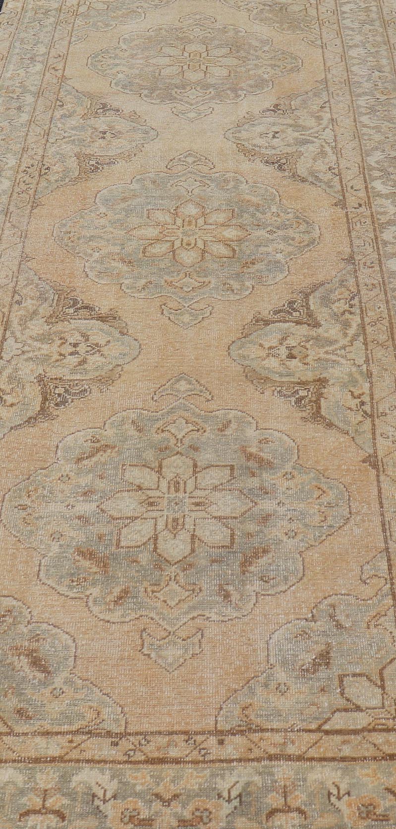 Measures: 4'3 x 11'7 Vintage Turkish Gallery Rug in Earth Tones & Light Grey with Floral Medallions. Keivan Woven Arts / Rug / EN - 178758, Keivan Woven Arts / country of origin / type: Turkey / Oushak, circa 1940. This beautiful vintage Ousha... - Keivan Woven ArtsEN - 178758 - 21925Rug