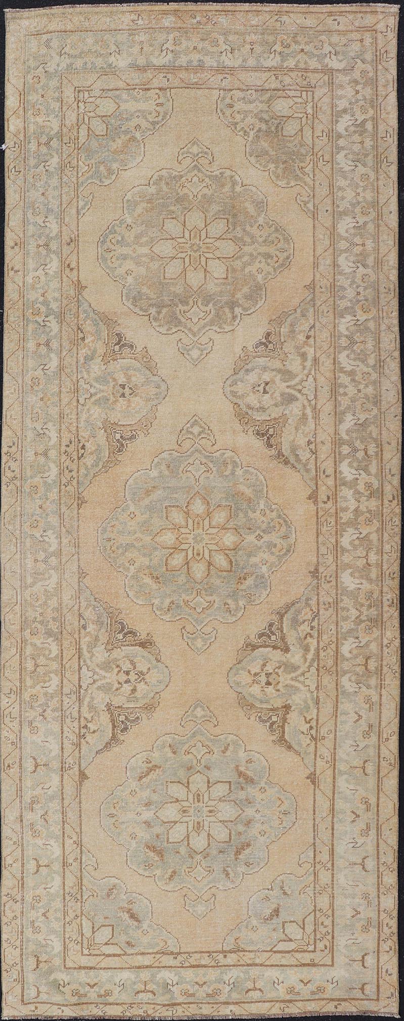 Measures: 4'3 x 11'7 Vintage Turkish Gallery Rug in Earth Tones & Light Grey with Floral Medallions. Keivan Woven Arts / Rug / EN - 178758, Keivan Woven Arts / country of origin / type: Turkey / Oushak, circa 1940. This beautiful vintage Ousha... - Keivan Woven ArtsEN - 178758 - 21925Rug