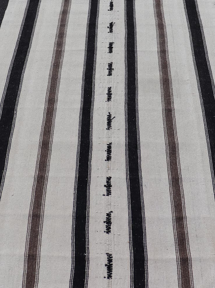 Vintage Turkish Kilim with Stripes in Ivory and Shades of Brown Measures 4'4 x 6'10 This vintage Turkish Kilim features simple design and neutral colors, giving these types of rugs a rise in popularity in modern interiors of the 2020's. ... - Keivan Woven ArtsEN - 178921 - 18902Rug
