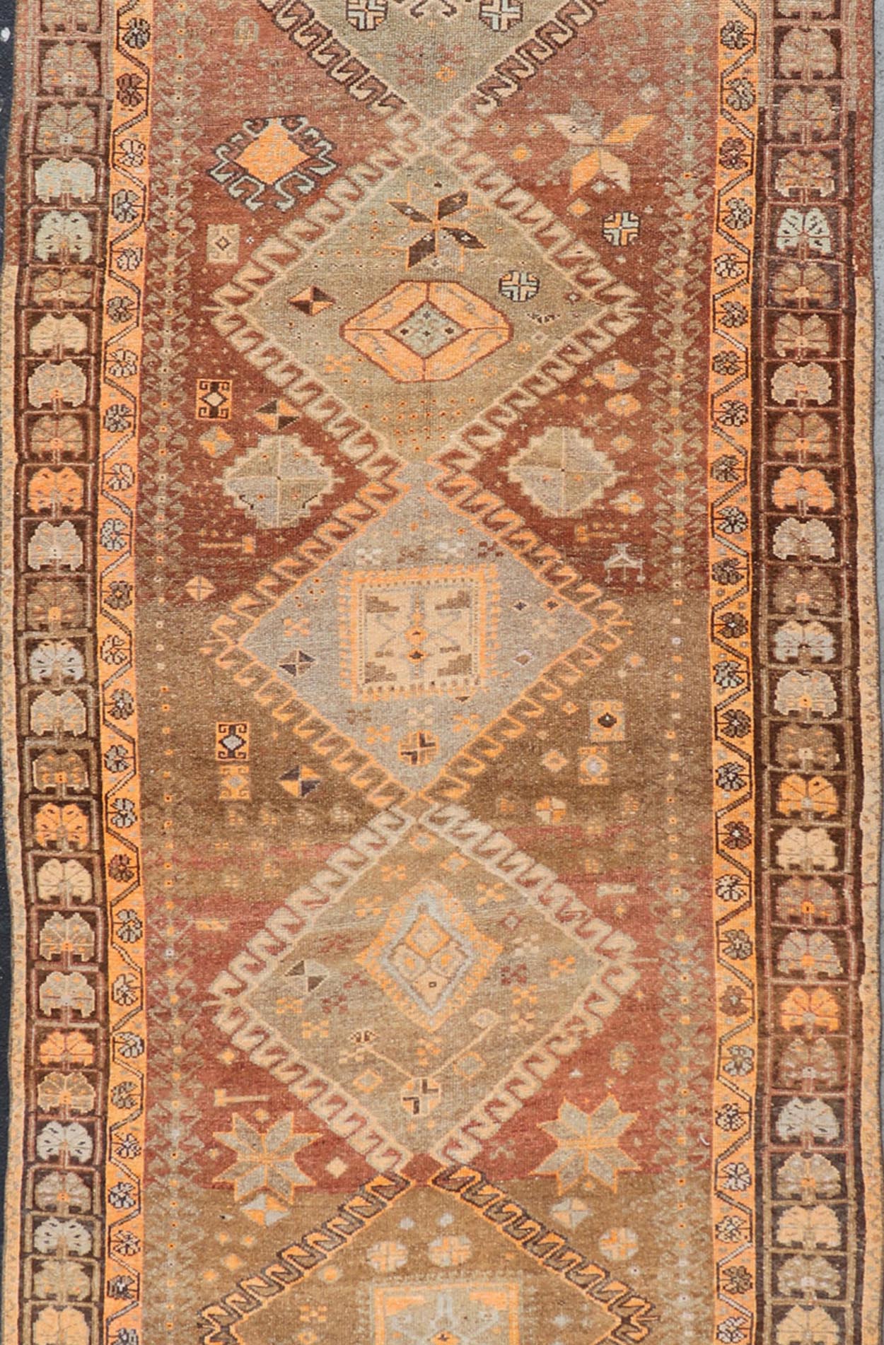 Vintage Hand Knotted Turkish Kars Gallery Rug in Wool with Diamond Design This antique Turkish Kars rug has been hand - knotted in wool and features an all - over, sub - geometric diamond design rendered in orange and earthy tones. A complementary, m... - Keivan Woven ArtsEN - 178983 - 19844