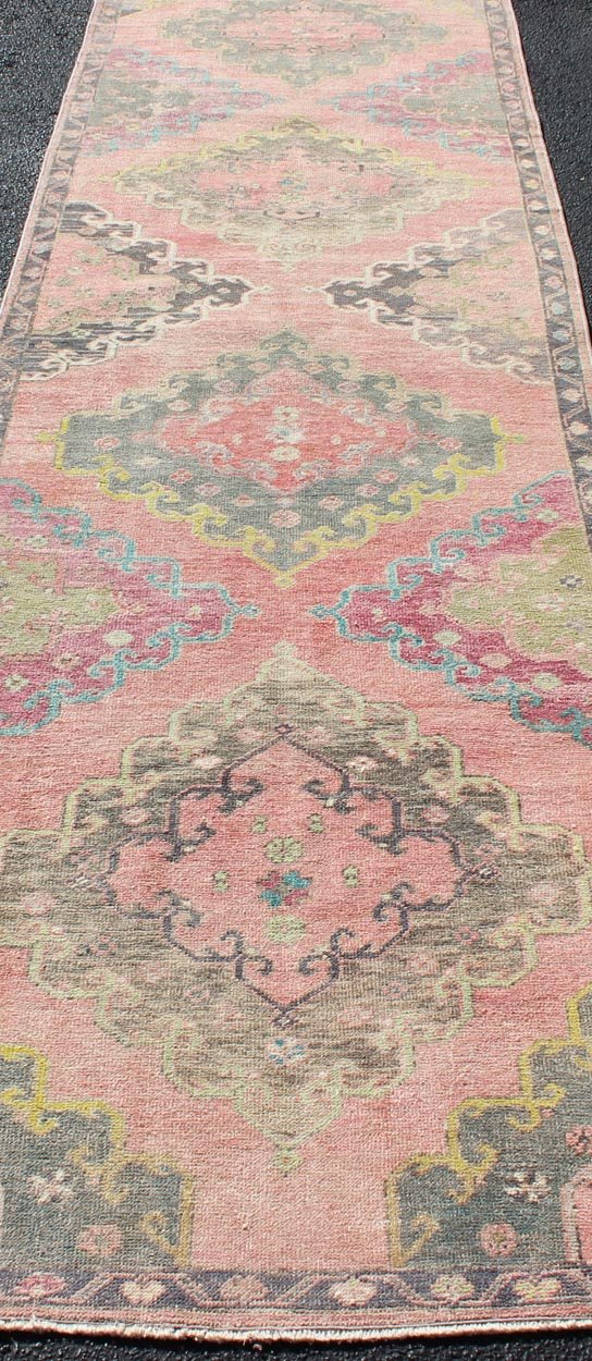 Colorful Vintage Turkish Oushak Runner with Four Medallion Design in Muted Colors. Measures: 3'4 x 12'3. This vintage Turkish Oushak runner features four layered medallions expanding across the central field. The surrounding border featu... - Keivan Woven ArtsEN - 179063 - 12349Rug