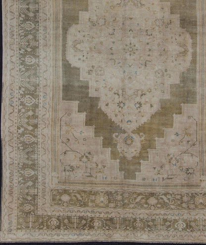 Medallion Vintage Turkish Oushak Rug in Olive Green, Army Green, Tan, Teal & Yellow and Muted Tones. Beautiful and unique color Turkish Oushak vintage in Olive and Army green background and border, and soft tones of tan. taupe, blush yellow and... - Keivan Woven ArtsEN - 179178 - 11992Rug