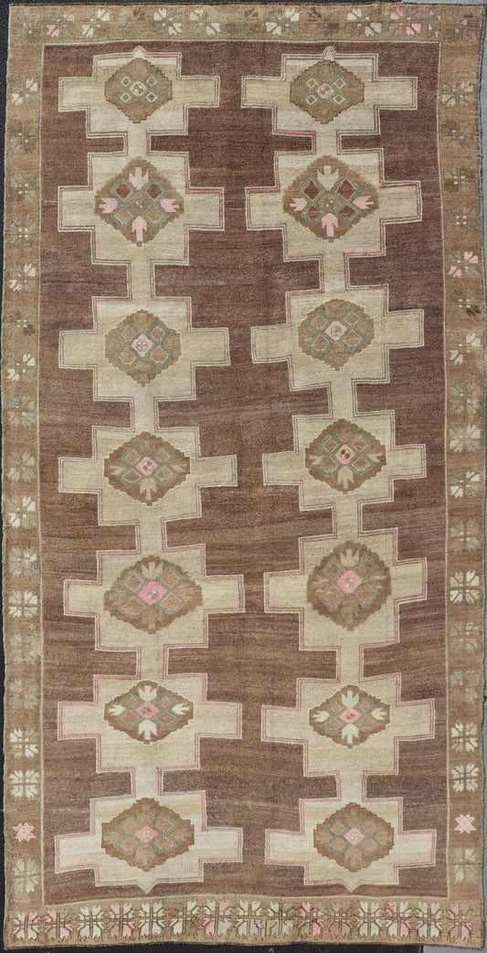 Vintage Kars Wide Gallery Rug in Brown Colors, Tan, Taupe and Light Green. Stacked in two rows of geometric medallions, this Vintage Turkish Kars wide gallery runner displays great geometry in chocolate Brown background with Colors such as Tan,... - Keivan Woven ArtsEN - 179569 - 14374Rug
