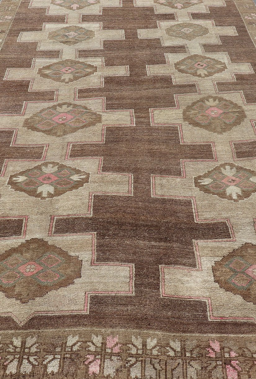 Vintage Kars Wide Gallery Rug in Brown Colors, Tan, Taupe and Light Green. Stacked in two rows of geometric medallions, this Vintage Turkish Kars wide gallery runner displays great geometry in chocolate Brown background with Colors such as Tan,... - Keivan Woven ArtsEN - 179569 - 14374Rug