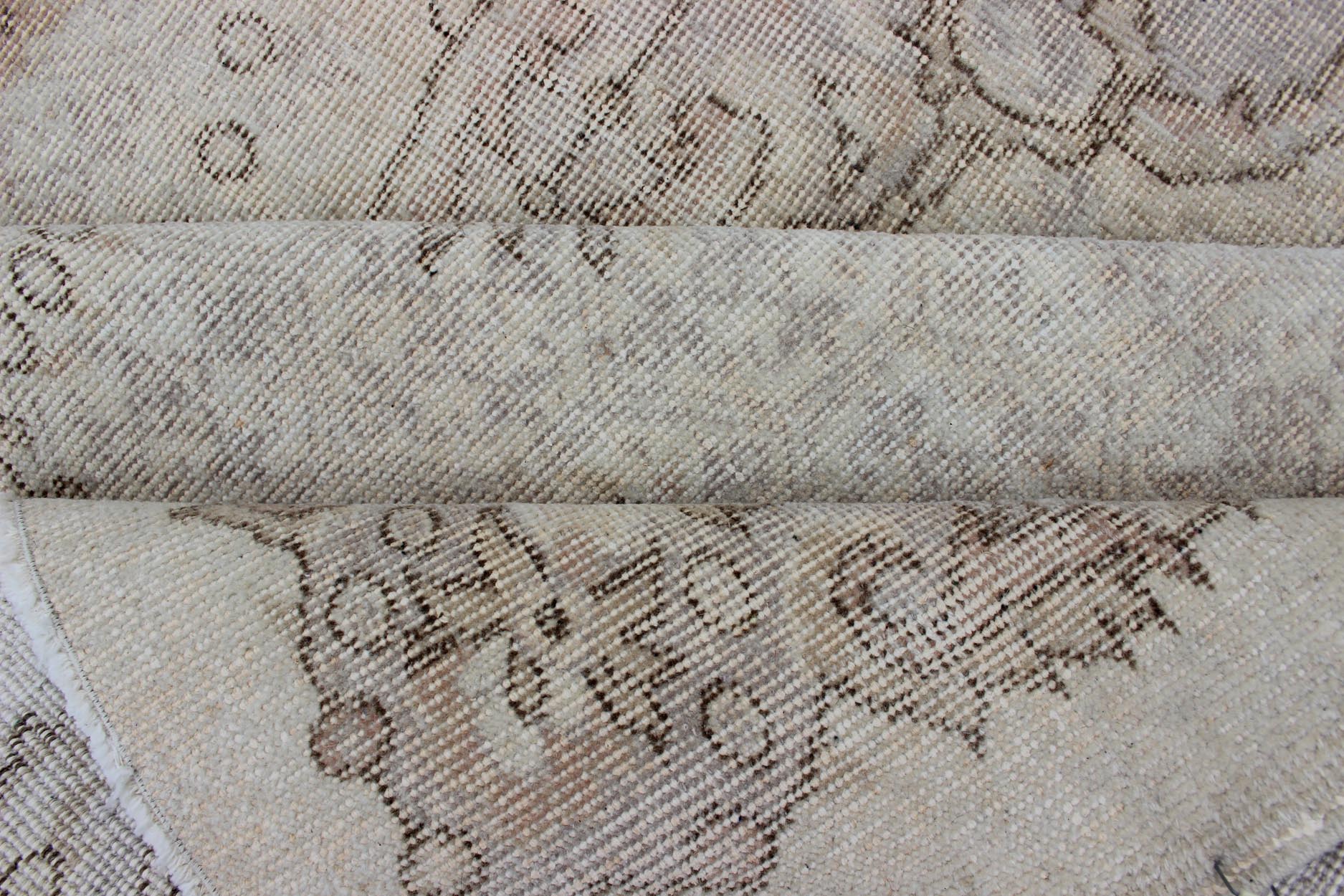 Keivan Woven Arts Vintage Turkish Distressed Rug in Sand, Cream, lavender, Taupe with brown highlights Measures:6'7 x 10'5 Sand, Taupe, cream and light lavender distressed vintage rug from Turkey with medallion design of etched motifs, ... - Keivan Woven ArtsEN - 179640 - 12627Rug