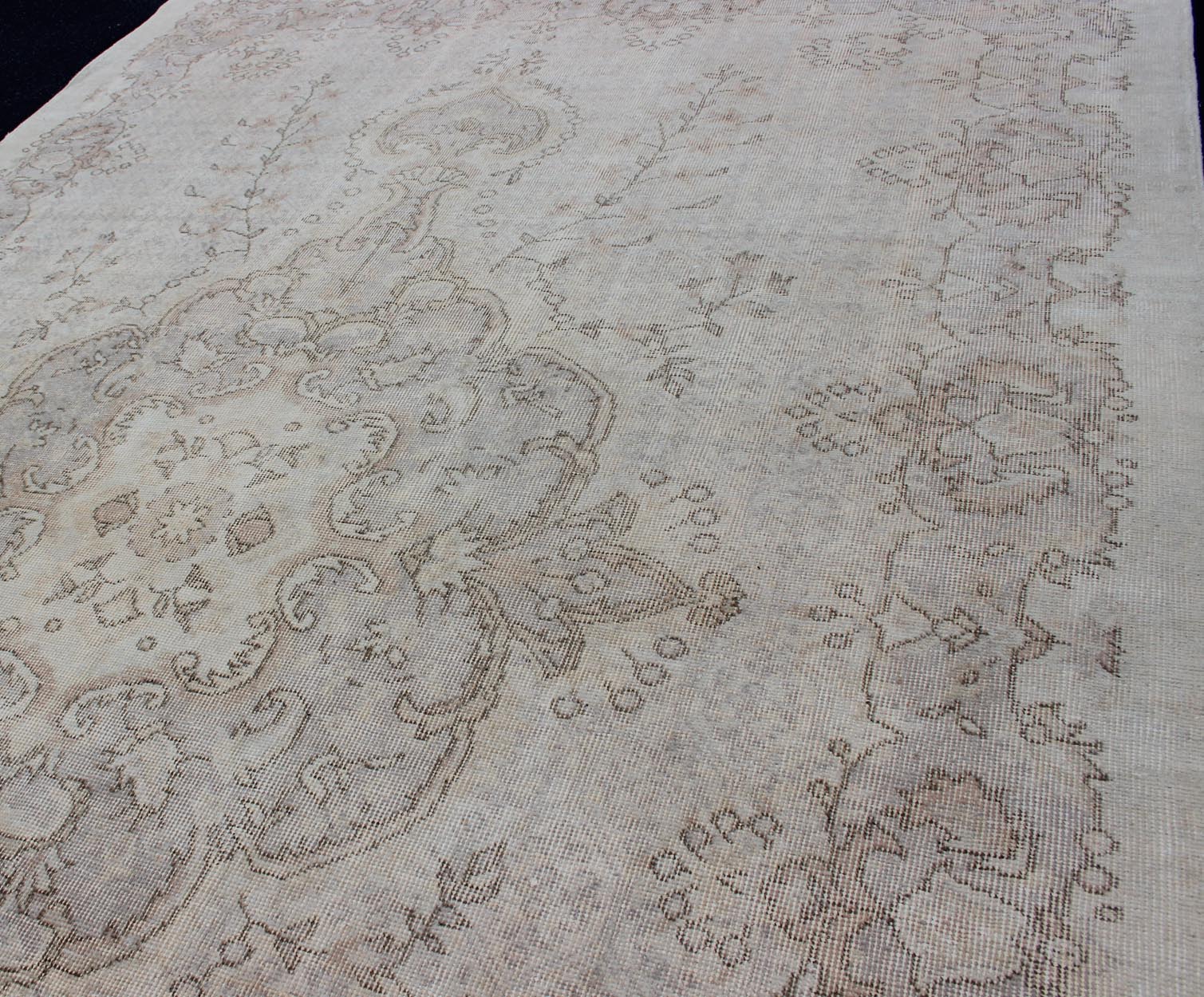 Keivan Woven Arts Vintage Turkish Distressed Rug in Sand, Cream, lavender, Taupe with brown highlights Measures:6'7 x 10'5 Sand, Taupe, cream and light lavender distressed vintage rug from Turkey with medallion design of etched motifs, ... - Keivan Woven ArtsEN - 179640 - 12627Rug