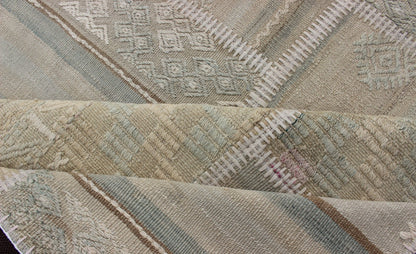 Large Turkish Kilim in Tan, Blue, Taupe, Light Green & Neutral Colors Large Turkish kilim from vintage pieces skillfully put together. this fine patchwork rug has light green, tan, taupe, blue, cream, brown and neutral tones. Keivan Woven Arts rug/... - Keivan Woven ArtsEN - 179675 - 12803Rug