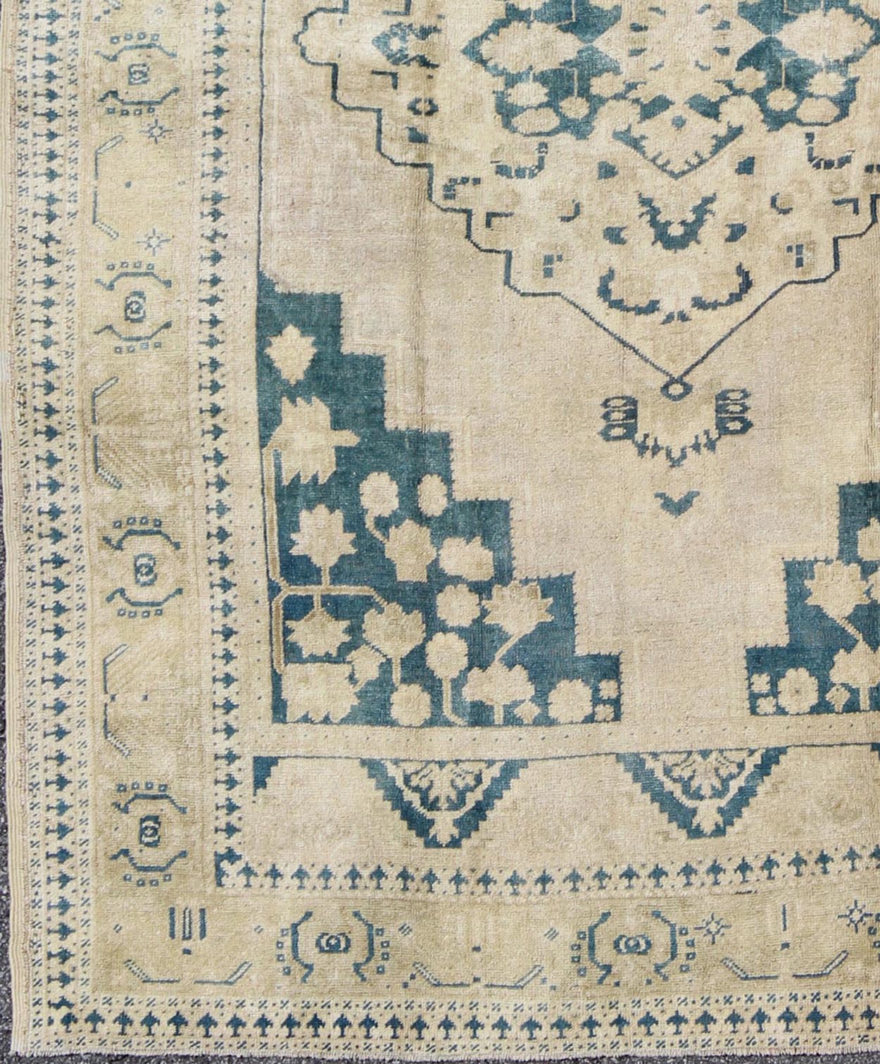 Turkish Oushak Rug This geometric Turkish Oushak carpet rests beautifully upon an ivory background with a cream border. A blue outlined medallion takes center stage and is well balanced by four organic corner motifs composed of the same blue and... - Keivan Woven ArtsEN - 240 - 3064Rug