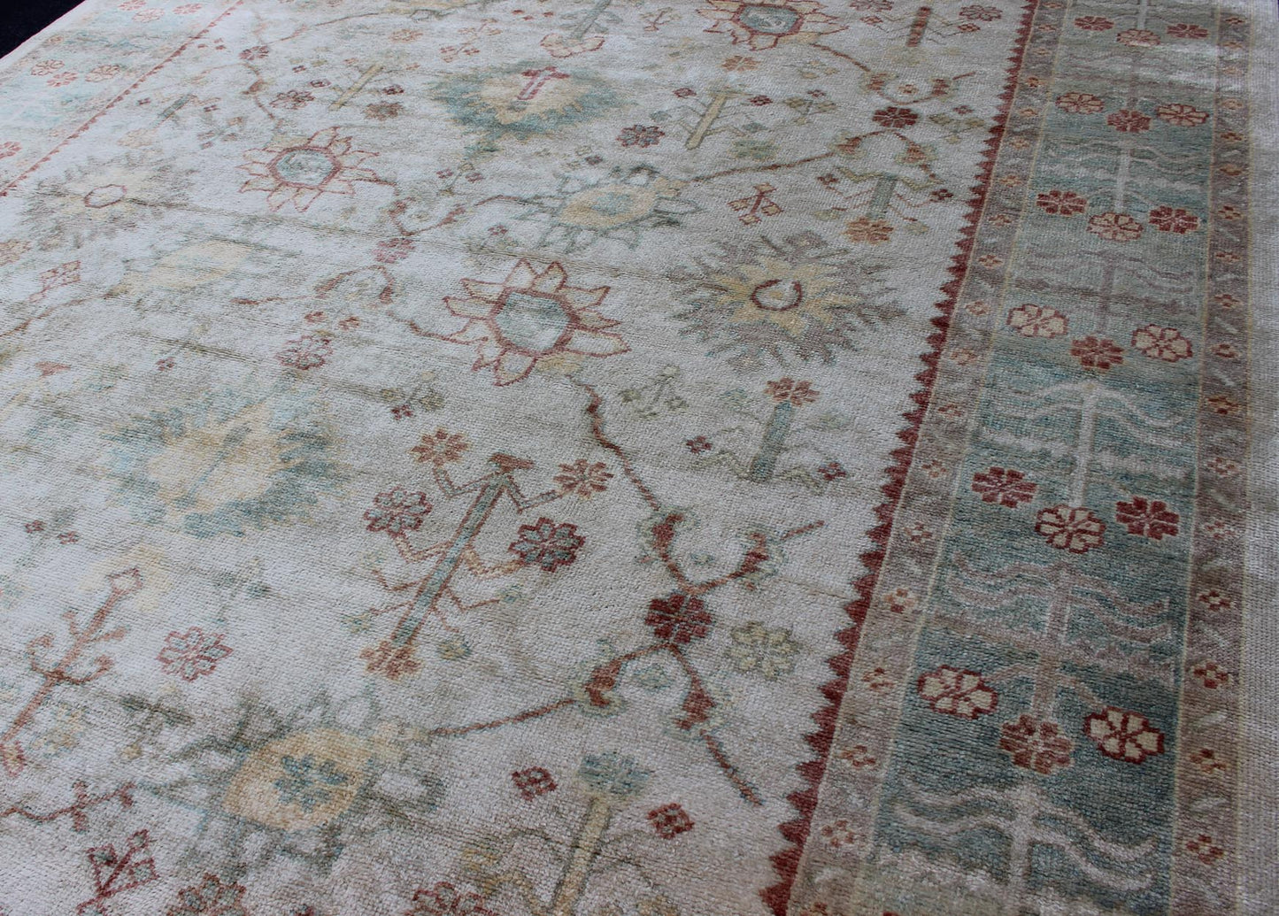 Antique Reproduction Turkish Oushak. Measures: 9'4 x 11'4. This sub geometric Oushak rug from Turkey features subdued colors in blue, light green, rust and, neutral color palette and an all - over design of floral shapes, surrounded beautifully by ... - Keivan Woven ArtsEN - 3264 - 5452