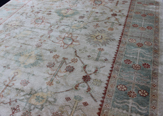 Antique Reproduction Turkish Oushak. Measures: 9'4 x 11'4. This sub geometric Oushak rug from Turkey features subdued colors in blue, light green, rust and, neutral color palette and an all - over design of floral shapes, surrounded beautifully by ... - Keivan Woven ArtsEN - 3264 - 5452