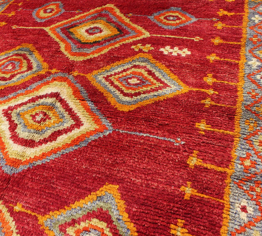 Tribal Turkish Konya Rug With Diamond Design in Beautiful Royal Red Background This brilliant Tribal Konya rug showcases a multi - layered diamond pattern with a range of green, orange, yellow and blue that glow in the bright red field. A light gr... - Keivan Woven ArtsEN - 3270 - 5456Rug