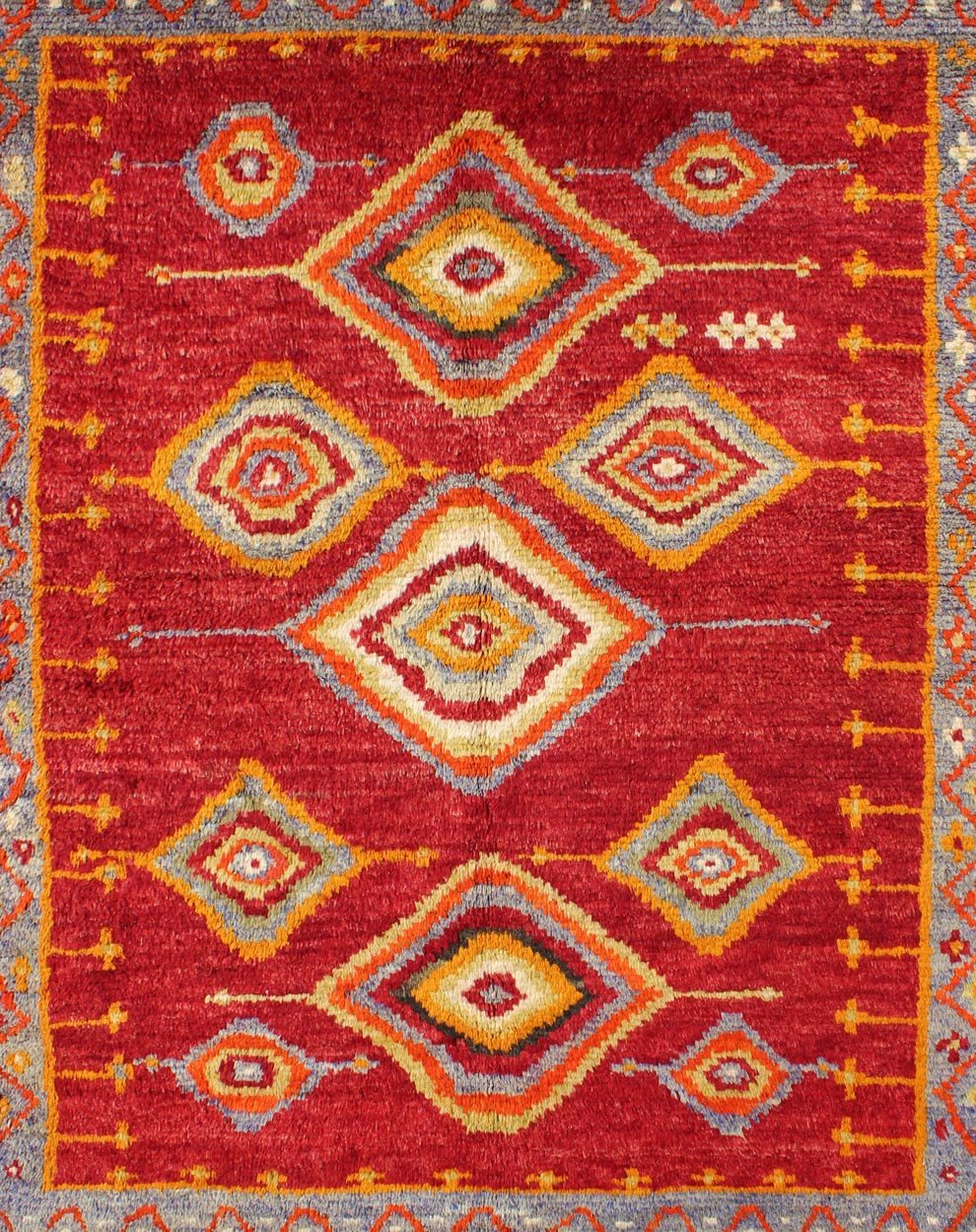 Tribal Turkish Konya Rug With Diamond Design in Beautiful Royal Red Background This brilliant Tribal Konya rug showcases a multi - layered diamond pattern with a range of green, orange, yellow and blue that glow in the bright red field. A light gr... - Keivan Woven ArtsEN - 3270 - 5456Rug