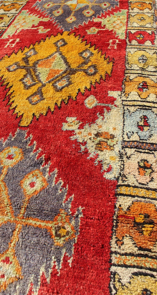 Tribal Turkish Oushak Runner This cheerful Oushak runner contains a unique blend of colors along with geometric design. The multi - layered diamond medallions are complemented by asymmetrical and tribal motifs. The various shades of yellow, gold, ... - Keivan Woven ArtsEN - 3308 - 5498Rug