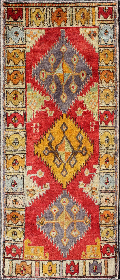 Tribal Turkish Oushak Runner This cheerful Oushak runner contains a unique blend of colors along with geometric design. The multi - layered diamond medallions are complemented by asymmetrical and tribal motifs. The various shades of yellow, gold, ... - Keivan Woven ArtsEN - 3308 - 5498Rug