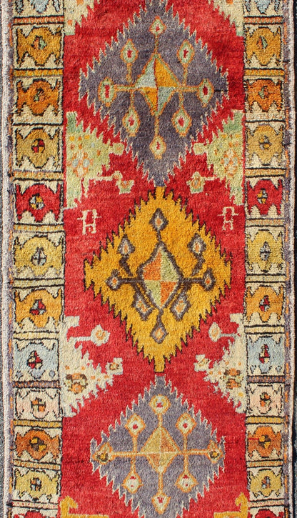 Tribal Turkish Oushak Runner This cheerful Oushak runner contains a unique blend of colors along with geometric design. The multi - layered diamond medallions are complemented by asymmetrical and tribal motifs. The various shades of yellow, gold, ... - Keivan Woven ArtsEN - 3308 - 5498Rug