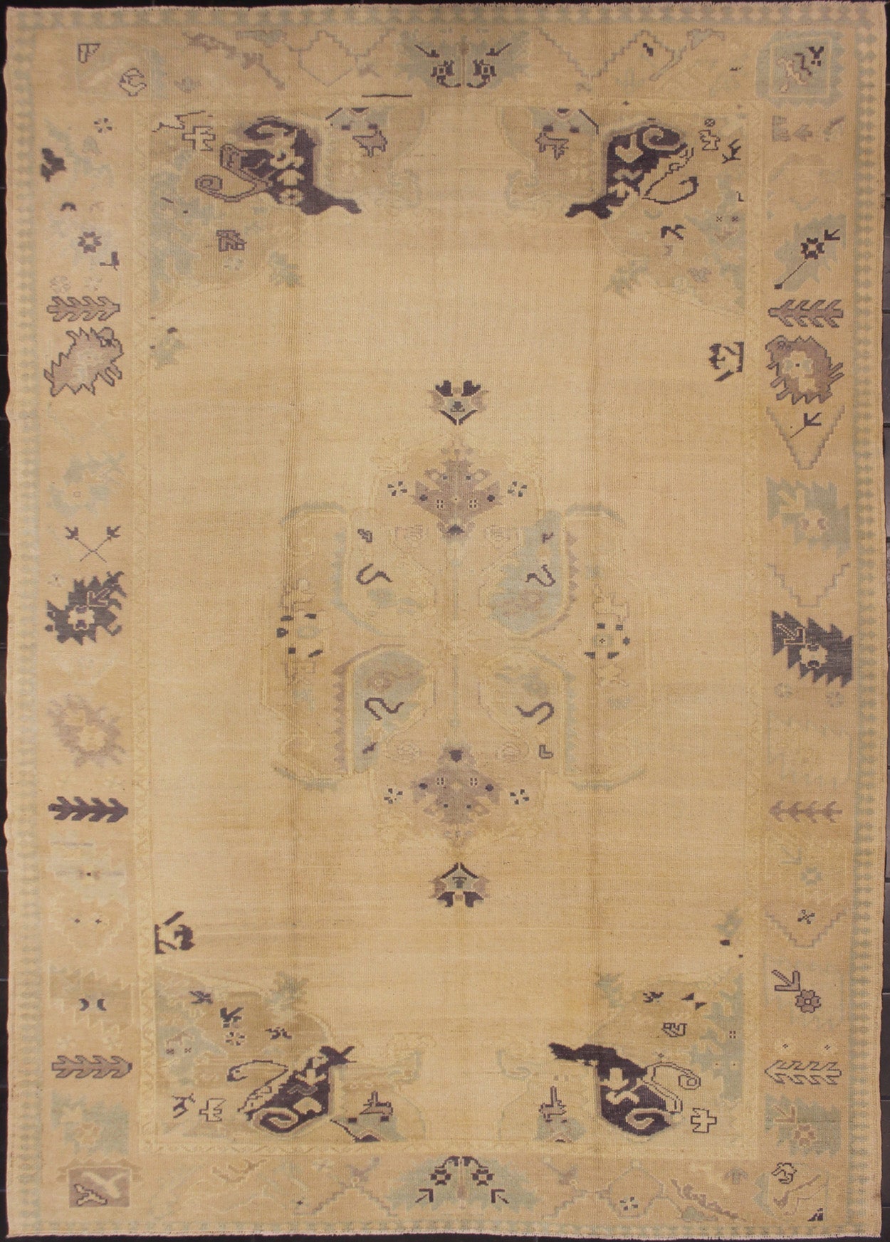 Muted Turkish Oushak Rug with Light Gray Field and Blue Accents This muted Oushak carpet rests beautifully upon a field of elegant light buttery color. A large medallion takes center stage and is well balanced by four prominent organic corner mo... - Keivan Woven ArtsEN - 4375 - 4892Rug