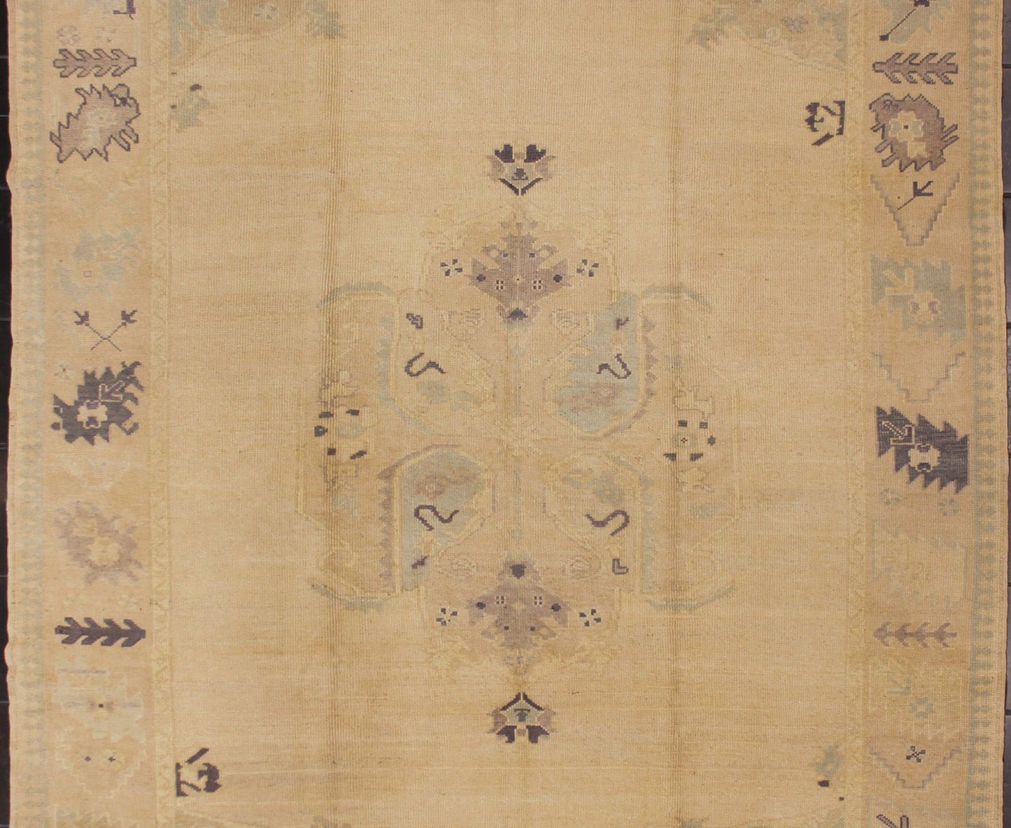 Muted Turkish Oushak Rug with Light Gray Field and Blue Accents This muted Oushak carpet rests beautifully upon a field of elegant light buttery color. A large medallion takes center stage and is well balanced by four prominent organic corner mo... - Keivan Woven ArtsEN - 4375 - 4892Rug