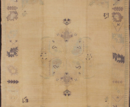 Muted Turkish Oushak Rug with Light Gray Field and Blue Accents This muted Oushak carpet rests beautifully upon a field of elegant light buttery color. A large medallion takes center stage and is well balanced by four prominent organic corner mo... - Keivan Woven ArtsEN - 4375 - 4892Rug