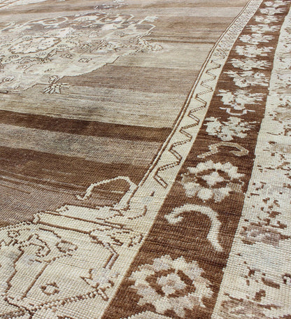 Unique Turkish Kars Carpet in Brown, Gray,and Ivory This striking and unique carpet combines a traditional center field with an Art Deco border and features a color palette including brown, cream, and ivory. Measures: 8'0 x 12'5. - Keivan Woven ArtsEN - 4607 - 1636Rug
