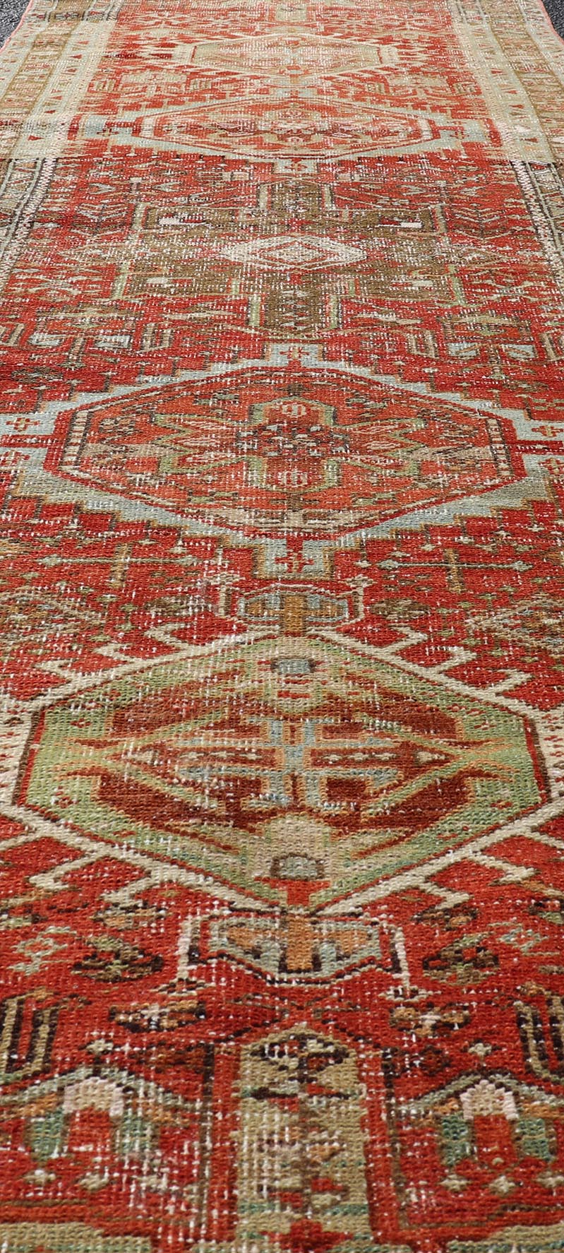 Measures: 2'8 x 10'6 Antique Persian Heriz Distressed Runner with Geometric Medallions in Soft Colors. rug EN - 4651, country of origin / type: Iran / Heriz, circa 1920 This antique Persian Heriz runner, from northwest Iran, displays a geometr... - Keivan Woven ArtsEN - 4651 - 19881Rug