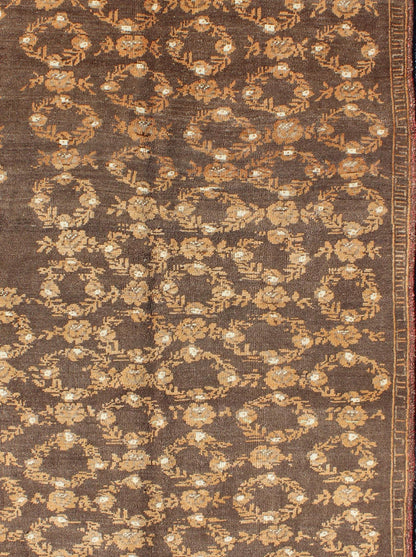 All - Over Floral Wreath Design Turkish Oushak Rug with Brown Background Measures: 4'5 x 7'4 The design of this beautiful vintage Oushak rug from mid - 20th century Turkey is enhanced by its rich colored wool. The brown ground is home to an a... - Keivan Woven ArtsEN - 534 - 3678Rug