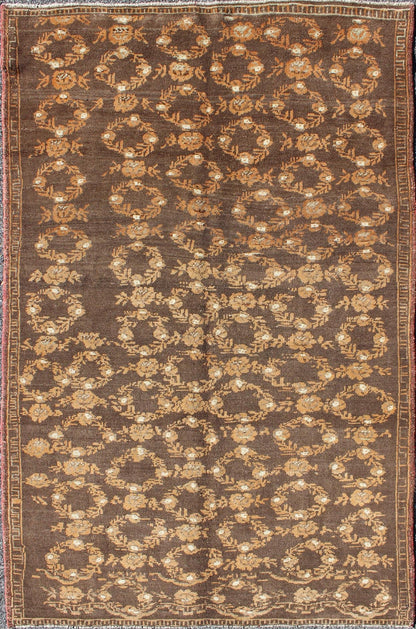 All - Over Floral Wreath Design Turkish Oushak Rug with Brown Background Measures: 4'5 x 7'4 The design of this beautiful vintage Oushak rug from mid - 20th century Turkey is enhanced by its rich colored wool. The brown ground is home to an a... - Keivan Woven ArtsEN - 534 - 3678Rug
