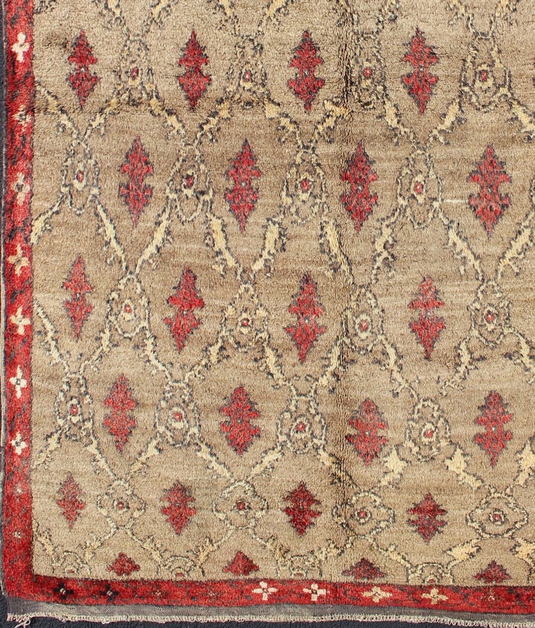 Mid Century Tulu Carpet in Sand color background. This mid century Tulu rug features repeating red motifs laid across a sand - colored field and enclosed within similarly - colored frames. Tulu rugs were woven in Konya area, in central Anato... - Keivan Woven ArtsEN - 623 - 4842Rug