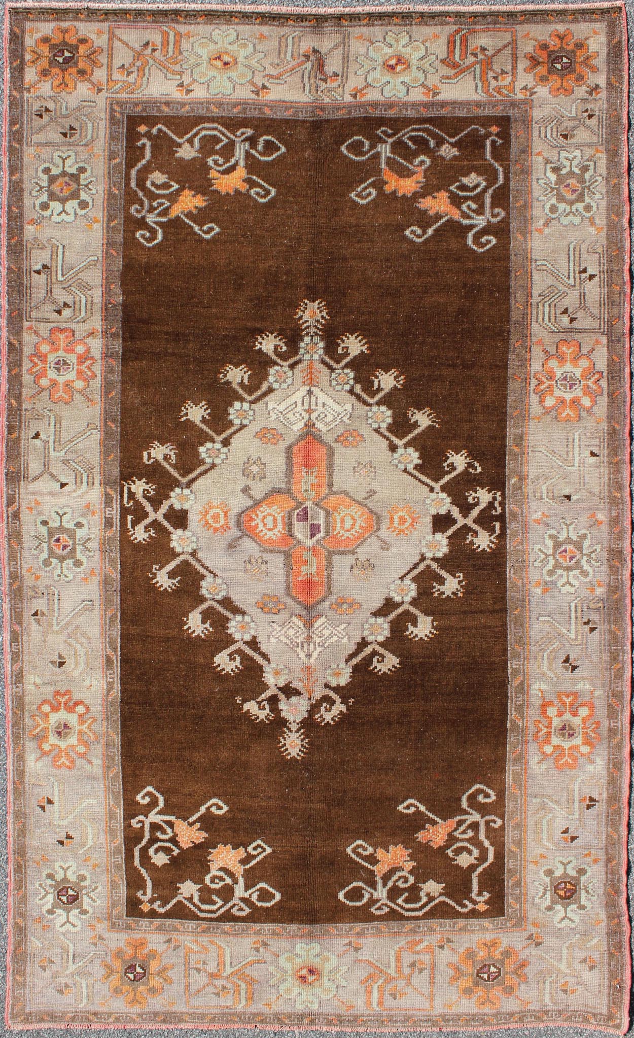 Vintage Turkish Medallion Oushak in Brown, Taupe, Gray, silver and Orange Measures: 5'1 x 8'10 This Turkish Oushak features a chocolate - brown background with a light gray and taupe border. The vibrant pop of orange color balances beautifu... - Keivan Woven ArtsEN - 6301 - 3824Rug