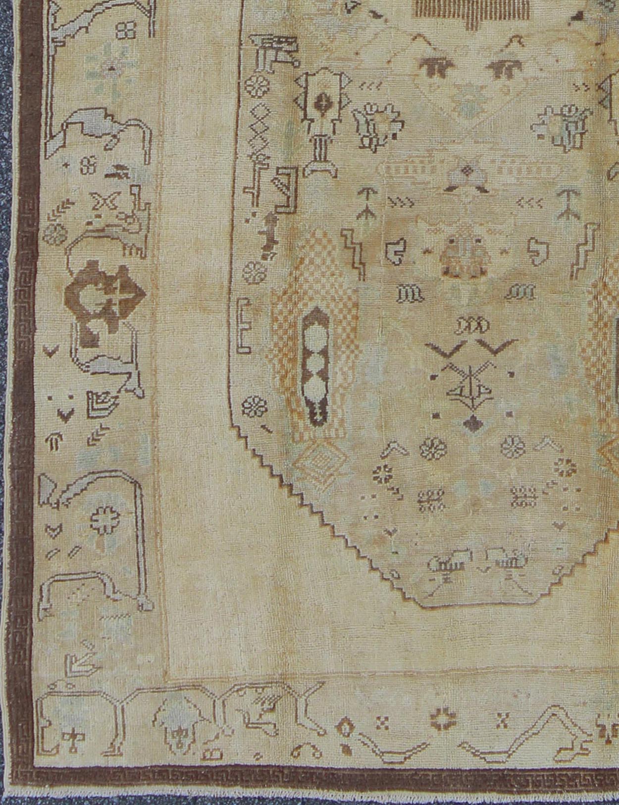 Vintage Turkish Oushak Carpet with Tribal Figures in an Earthy Color Palette Vintage Turkish Oushak Carpet with Tribal Figures in an Earthy Color Palette rug/en - 654 origin/ turkey kwarugs This vintage Turkish Oushak rug features an earthy... - Keivan Woven ArtsEN - 654 - 3820Rug