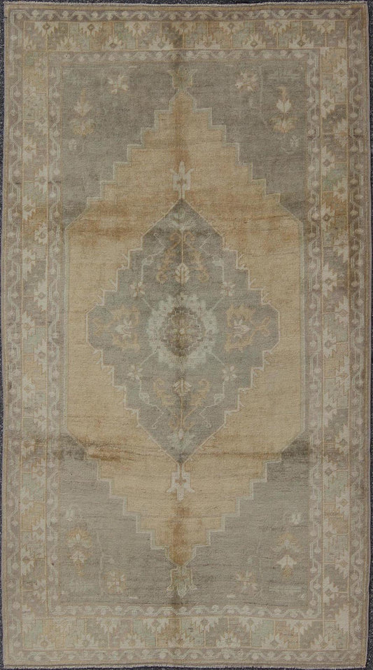 Muted Mid - 20th Century Vintage Oushak Rug with Medallion in Camel Measures: 5'5 x 9'4 This muted Turkish Oushak rests beautifully on a grounded camel - colored field. An understated medallion is well - balanced by four organic corner motifs, ... - Keivan Woven ArtsEN - 721 - 9236Rug