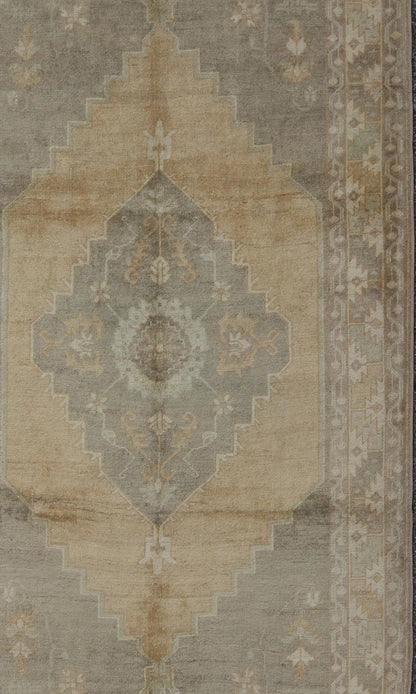 Muted Mid - 20th Century Vintage Oushak Rug with Medallion in Camel Measures: 5'5 x 9'4 This muted Turkish Oushak rests beautifully on a grounded camel - colored field. An understated medallion is well - balanced by four organic corner motifs, ... - Keivan Woven ArtsEN - 721 - 9236Rug