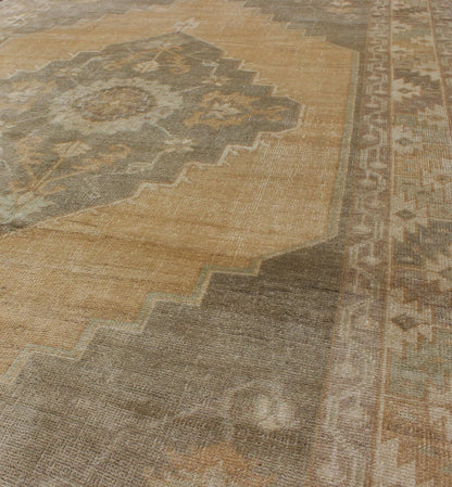Muted Mid - 20th Century Vintage Oushak Rug with Medallion in Camel Measures: 5'5 x 9'4 This muted Turkish Oushak rests beautifully on a grounded camel - colored field. An understated medallion is well - balanced by four organic corner motifs, ... - Keivan Woven ArtsEN - 721 - 9236Rug