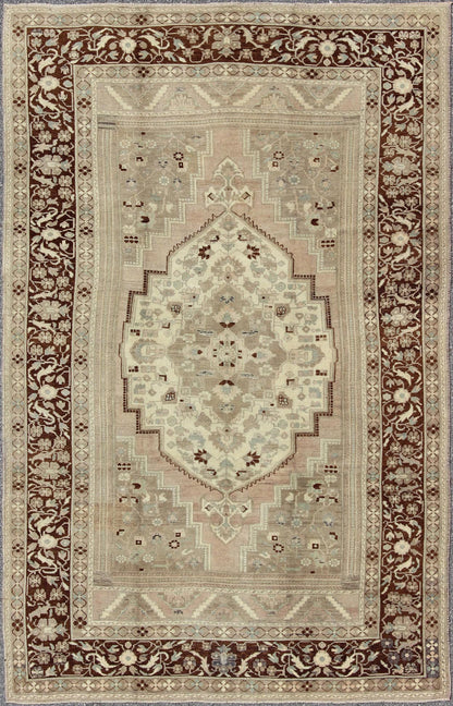 Charming Vintage Oushak Rug in Brown Border, Taupe, Blush and Gray/Green This rug showcases a large central medallion surrounded by a gentle pink color. A cream medallion is filled with floral designs of pale blue, light green, and shades of ne... - Keivan Woven ArtsEN - 786 - 3806Rug
