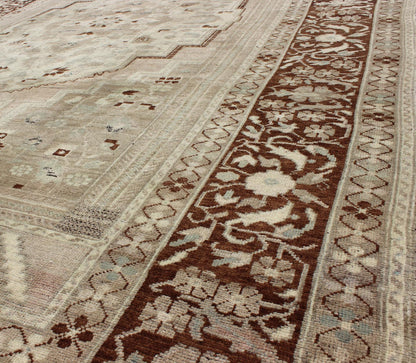 Charming Vintage Oushak Rug in Brown Border, Taupe, Blush and Gray/Green This rug showcases a large central medallion surrounded by a gentle pink color. A cream medallion is filled with floral designs of pale blue, light green, and shades of ne... - Keivan Woven ArtsEN - 786 - 3806Rug