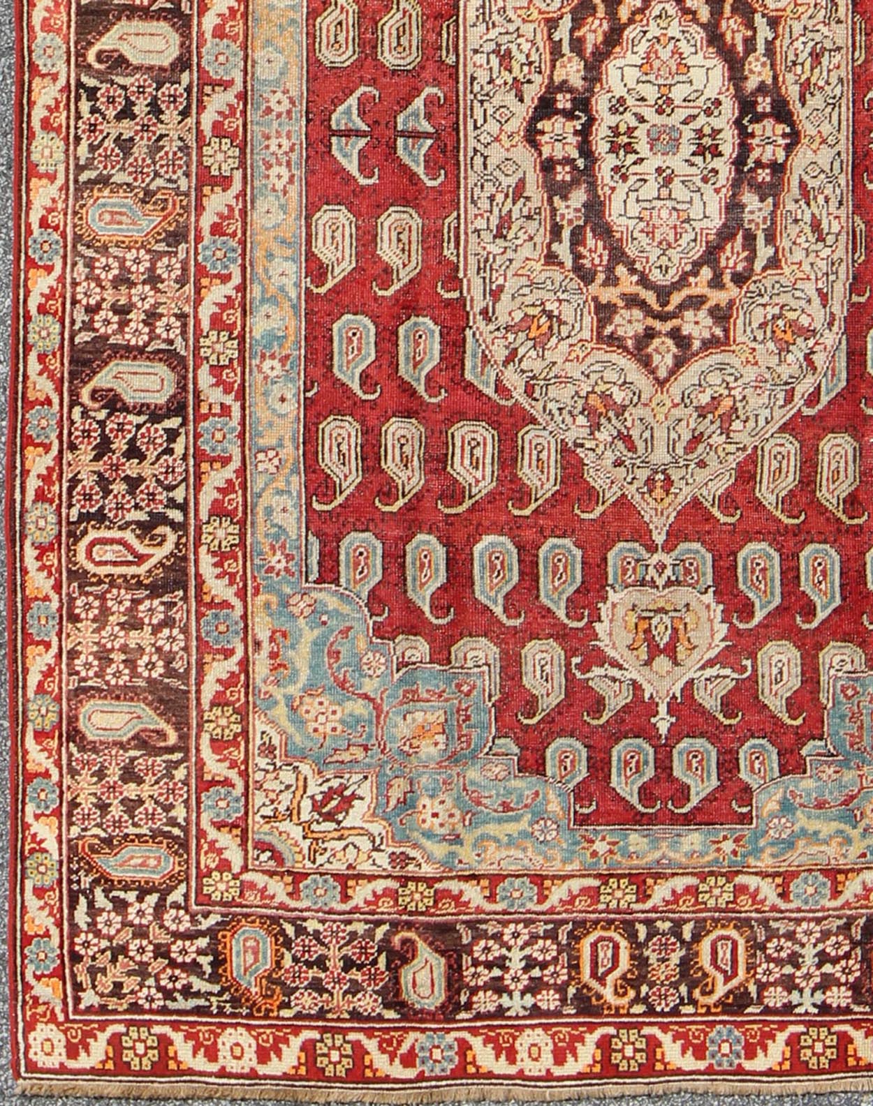 Antique Turkish Oushak Rug This stunning antique Turkish Oushak was beautifully handcrafted during the early part of the 20th Century. A regal sub - geometric design and center medallion rests upon a field of red. An intricate, broad border surrou... - Keivan Woven ArtsEN - 86834 - 898Rug
