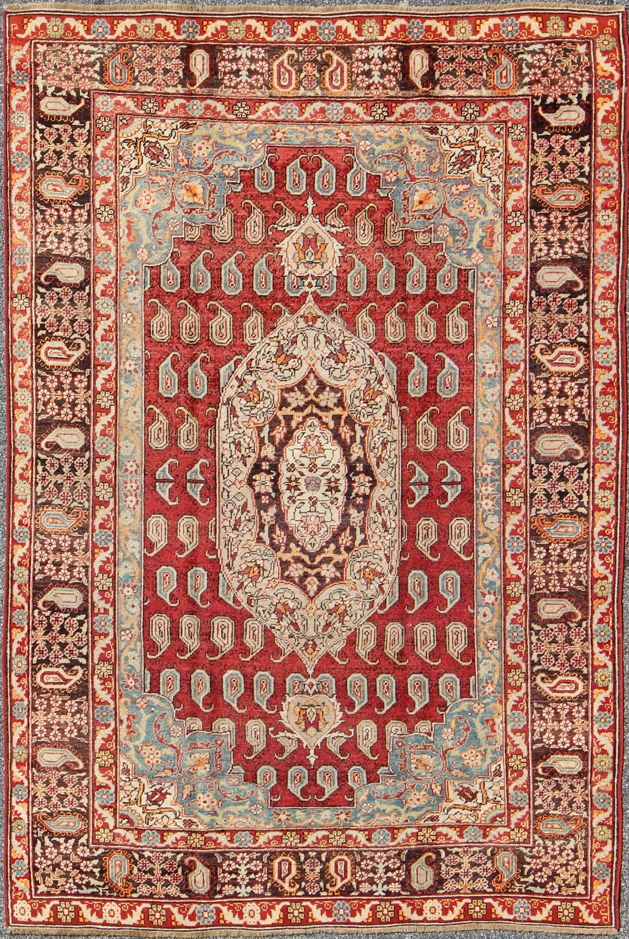 Antique Turkish Oushak Rug This stunning antique Turkish Oushak was beautifully handcrafted during the early part of the 20th Century. A regal sub - geometric design and center medallion rests upon a field of red. An intricate, broad border surrou... - Keivan Woven ArtsEN - 86834 - 898Rug