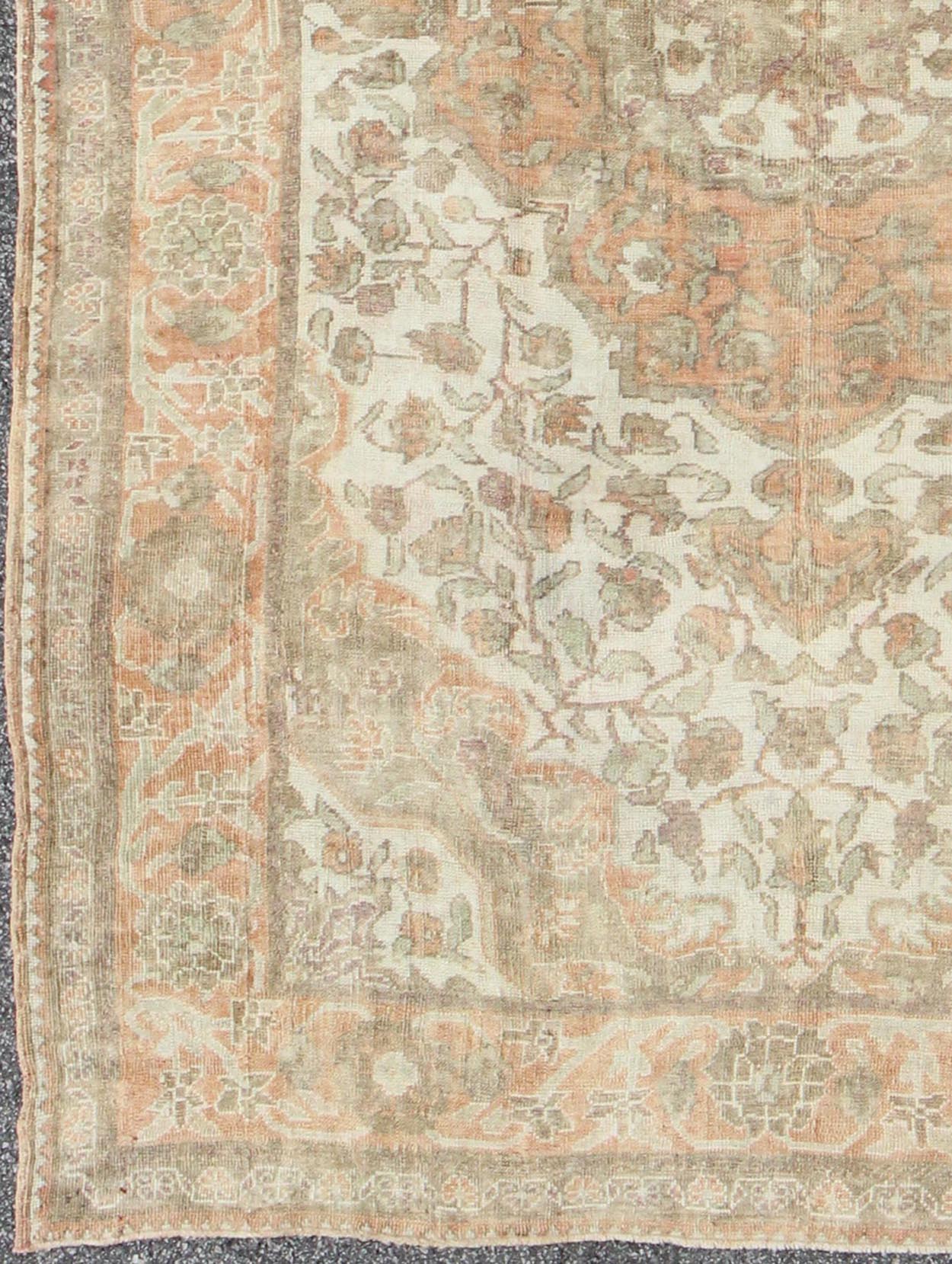 Vintage Turkish Oushak Rug in Peach, Ivory, Light Blue, and Light Green Measures: 6'9 x 9'3. This wonderful medallion Oushak features a soft color palette. The border has flowers connected by vines while the field also features a flower... - Keivan Woven ArtsEN - 92744 - 1656Rug