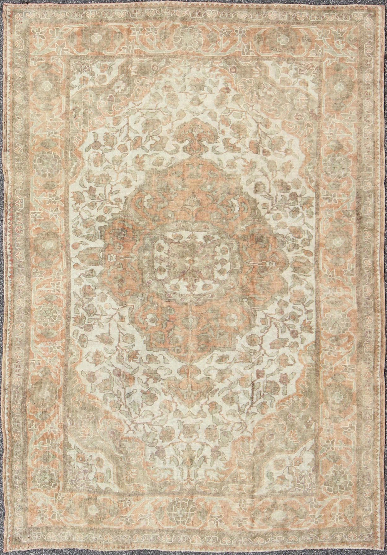 Vintage Turkish Oushak Rug in Peach, Ivory, Light Blue, and Light Green Measures: 6'9 x 9'3. This wonderful medallion Oushak features a soft color palette. The border has flowers connected by vines while the field also features a flower... - Keivan Woven ArtsEN - 92744 - 1656Rug