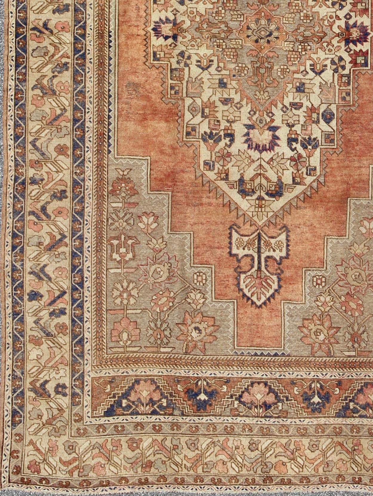 Vintage Turkish Oushak Rug This beautiful Turkish Oushak Rug has a medium blue color with a light orange background. The center medallion has earth tones with blues. The border has a rolling flower pattern. There are colors such as creamy yellow... - Keivan Woven ArtsEN - 94108 - 3158Rug