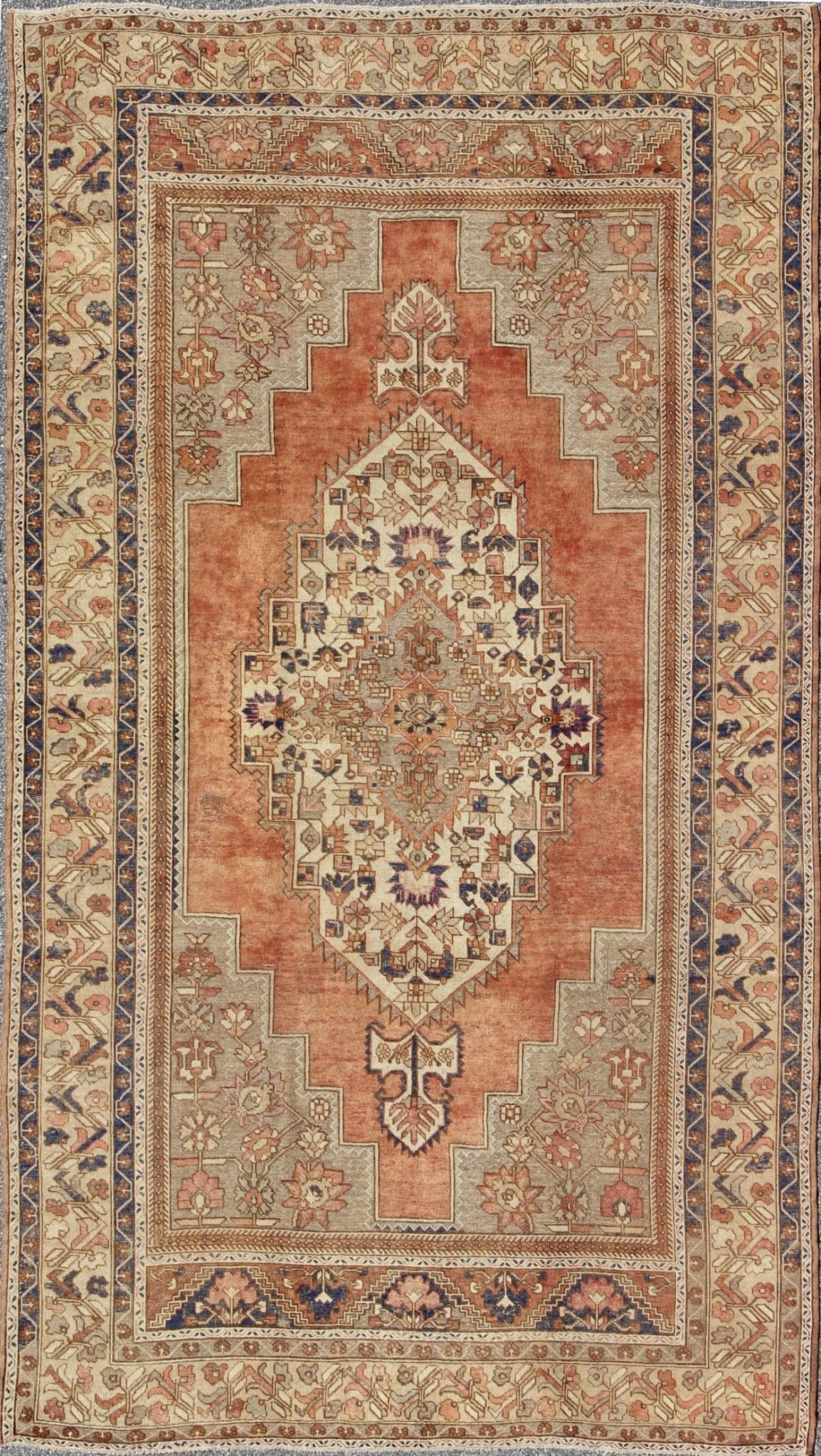 Vintage Turkish Oushak Rug This beautiful Turkish Oushak Rug has a medium blue color with a light orange background. The center medallion has earth tones with blues. The border has a rolling flower pattern. There are colors such as creamy yellow... - Keivan Woven ArtsEN - 94108 - 3158Rug