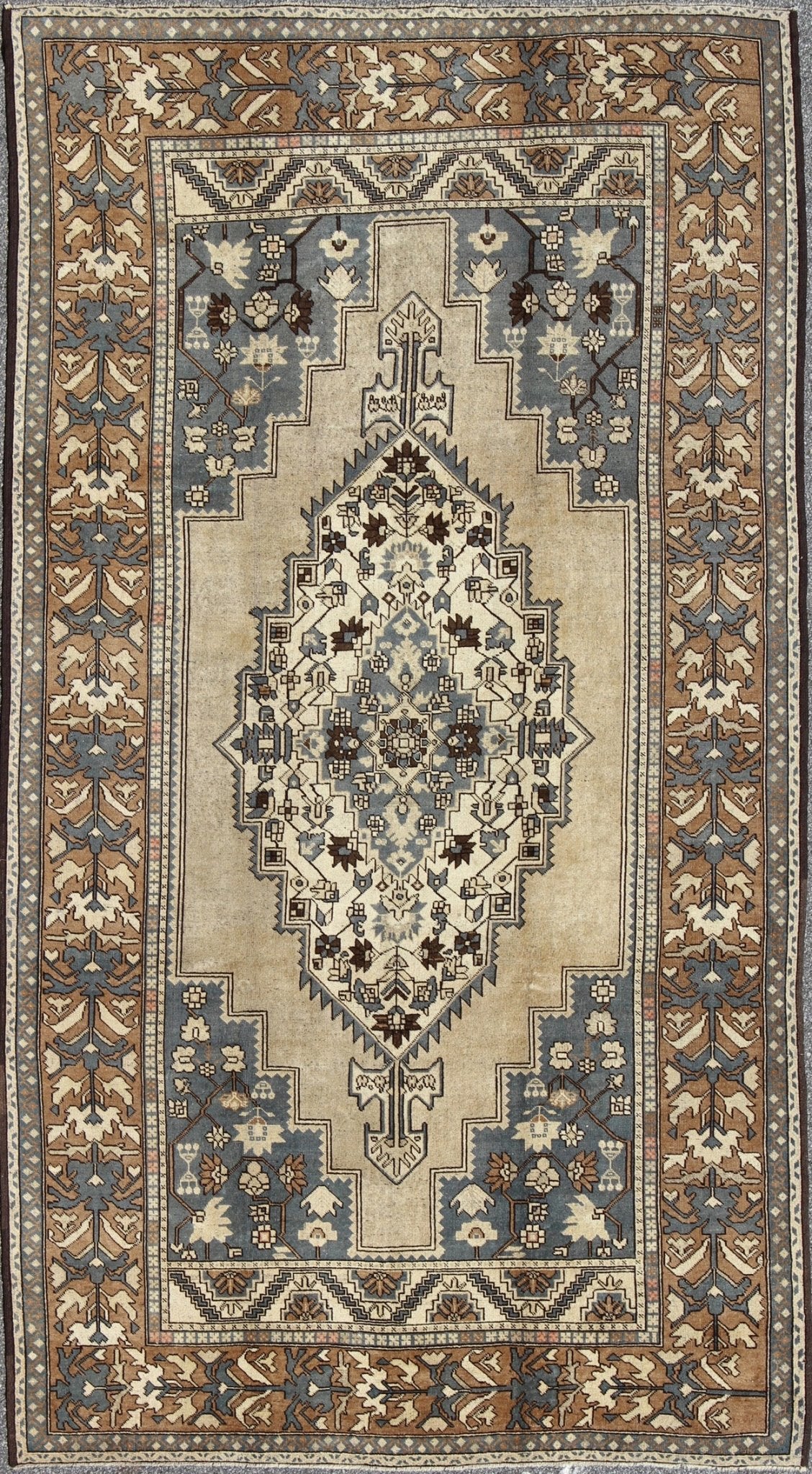 Vintage Turkish Medallion Oushak Rug in Rustic Blue, Mocha, and Taupe Measures: 7'2 x 12'9 Unique in its color palette and composition, this vintage Oushak features large - scale motifs and a central medallion. The field design is rendered... - Keivan Woven ArtsEN - 94123 - 3814Rug