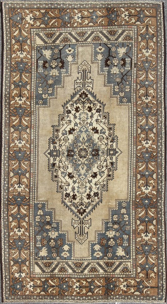 Vintage Turkish Medallion Oushak Rug in Rustic Blue, Mocha, and Taupe Measures: 7'2 x 12'9 Unique in its color palette and composition, this vintage Oushak features large - scale motifs and a central medallion. The field design is rendered... - Keivan Woven ArtsEN - 94123 - 3814Rug