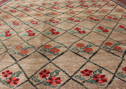 Turkish Konya Carpet in Camel Color Background, Red, Charcoal, Coral and Green. This colorful Turkish carpet rests beautifully upon a field of camel and light brown. A repeating flower pattern of taupe, green and gray takes center stage and is w... - Keivan Woven ArtsEN - 966 - 5434Rug