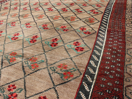 Turkish Konya Carpet in Camel Color Background, Red, Charcoal, Coral and Green. This colorful Turkish carpet rests beautifully upon a field of camel and light brown. A repeating flower pattern of taupe, green and gray takes center stage and is w... - Keivan Woven ArtsEN - 966 - 5434Rug