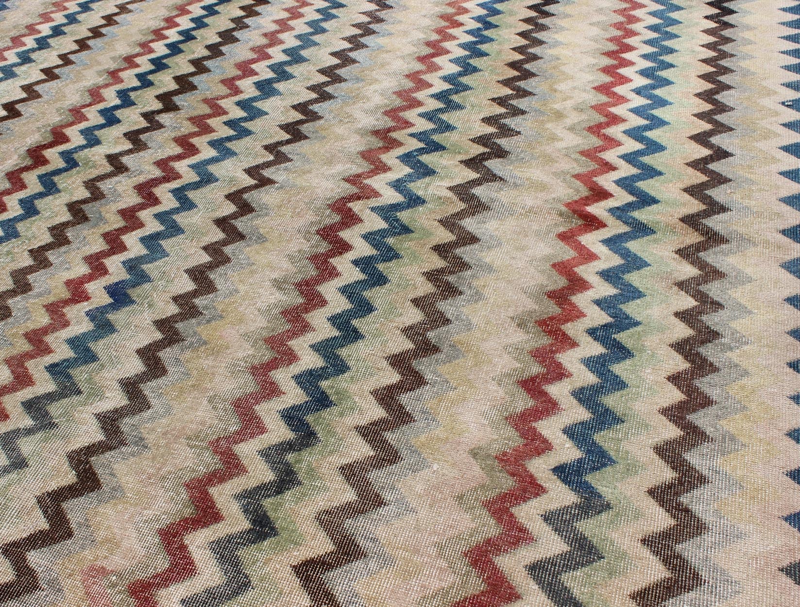 Mid - Century Turkish Modern Rug Rendered in zig - zag lines that run parallel to each other amidst an assortment of rich colors, this very unique rug showcases a modern design. Measures: 7'4 x 9'11. - Keivan Woven ArtsEN - 9801 - 4896Rug