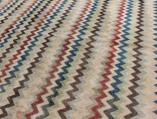 Mid - Century Turkish Modern Rug Rendered in zig - zag lines that run parallel to each other amidst an assortment of rich colors, this very unique rug showcases a modern design. Measures: 7'4 x 9'11. - Keivan Woven ArtsEN - 9801 - 4896Rug
